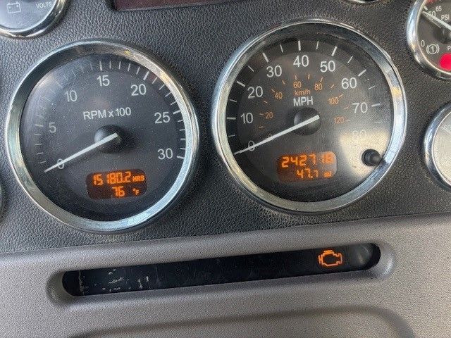 A close up of a dashboard with a speedometer that reads 4:27