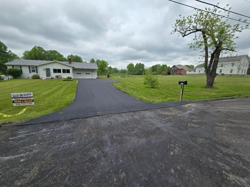 A house with a mailbox on the side of the road