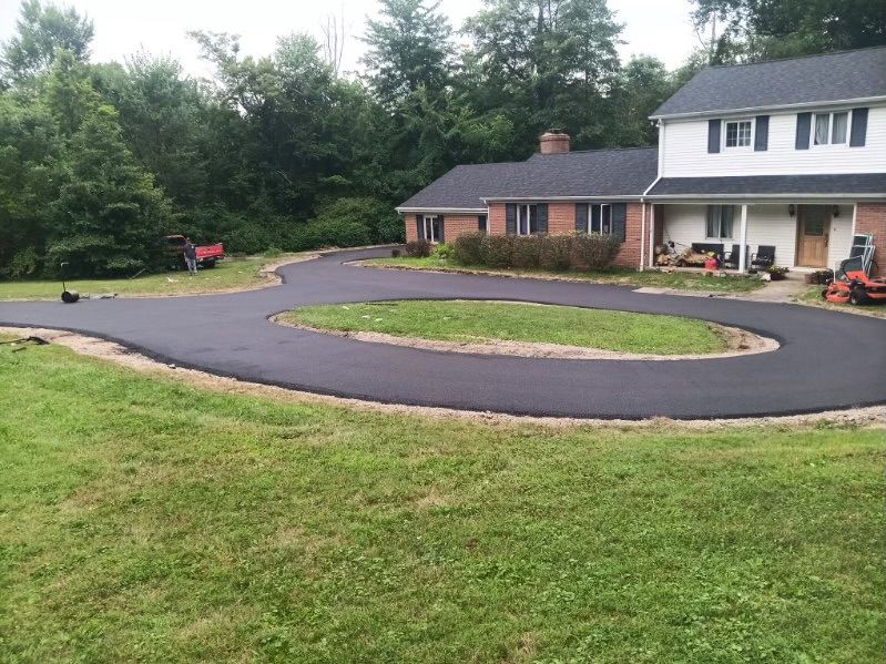 A large house with a circular driveway in front of it