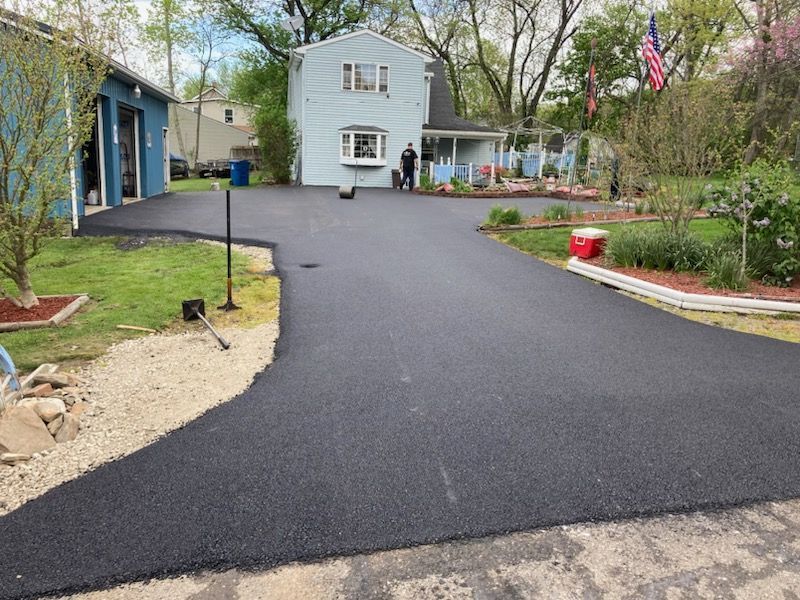 A driveway that has been paved in front of a house