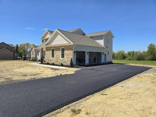 A large house with a driveway in front of it.