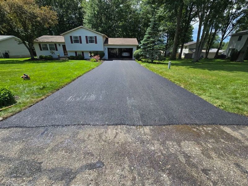 A driveway that has been paved in front of a house.