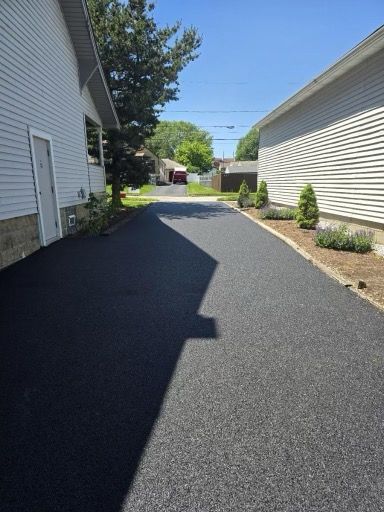 A driveway between two houses on a sunny day.