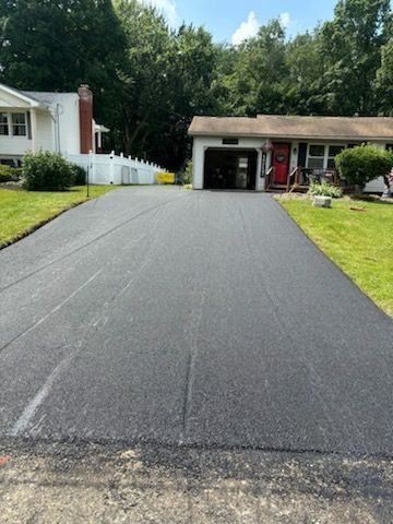 A driveway that has been paved in front of a house.