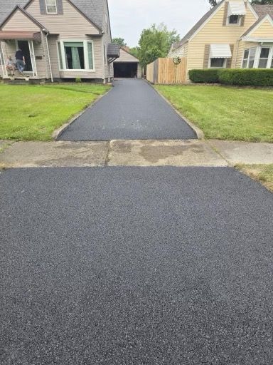 A driveway that has been paved in front of a house.