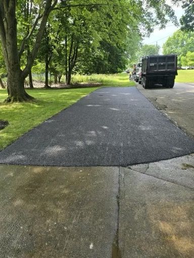 A dump truck is parked on the side of a road.