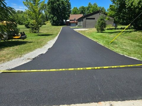 A driveway with a yellow tape measure on the side of it