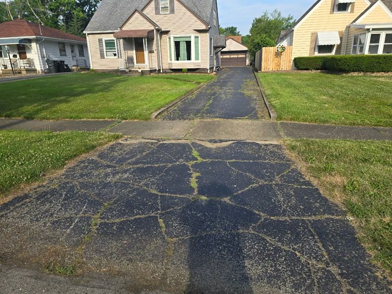 A driveway leading to a house with a garage