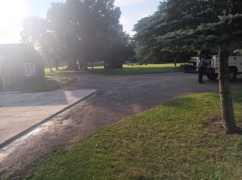 A white truck is parked on the side of the road in front of a house.
