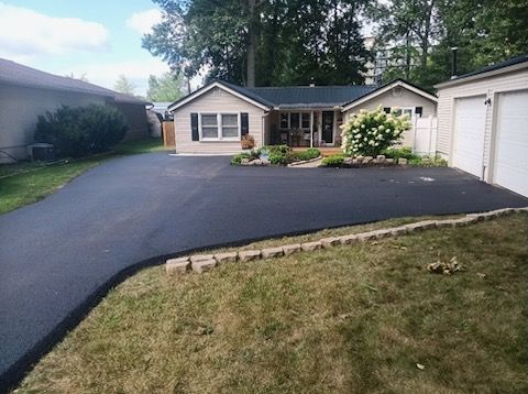 A house with a driveway leading to it and a garage.