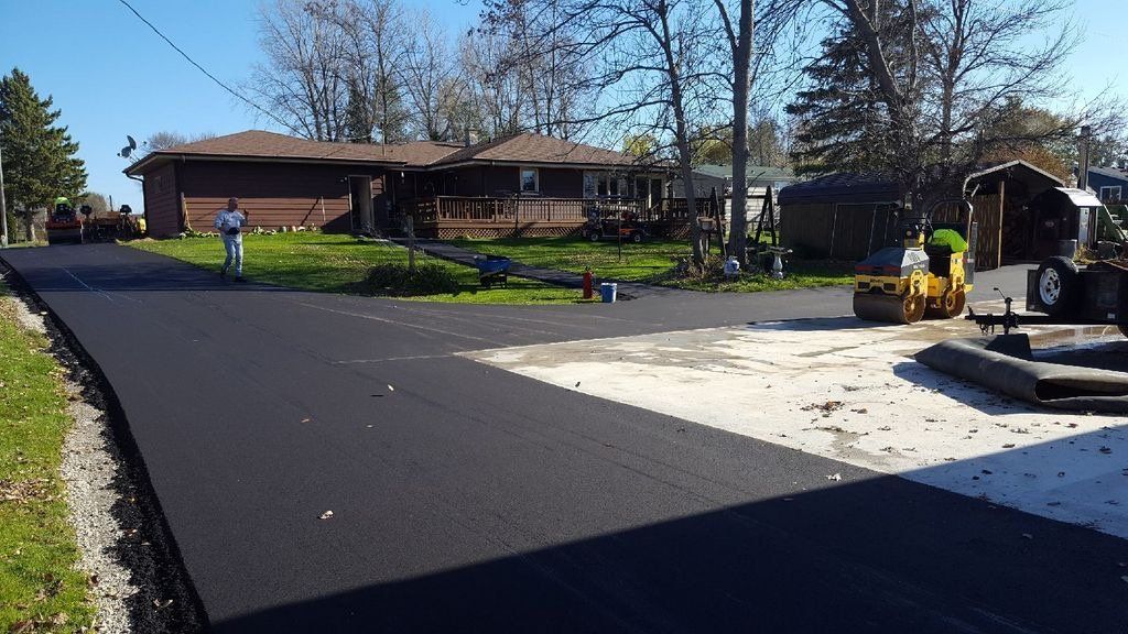 A road is being paved in front of a house