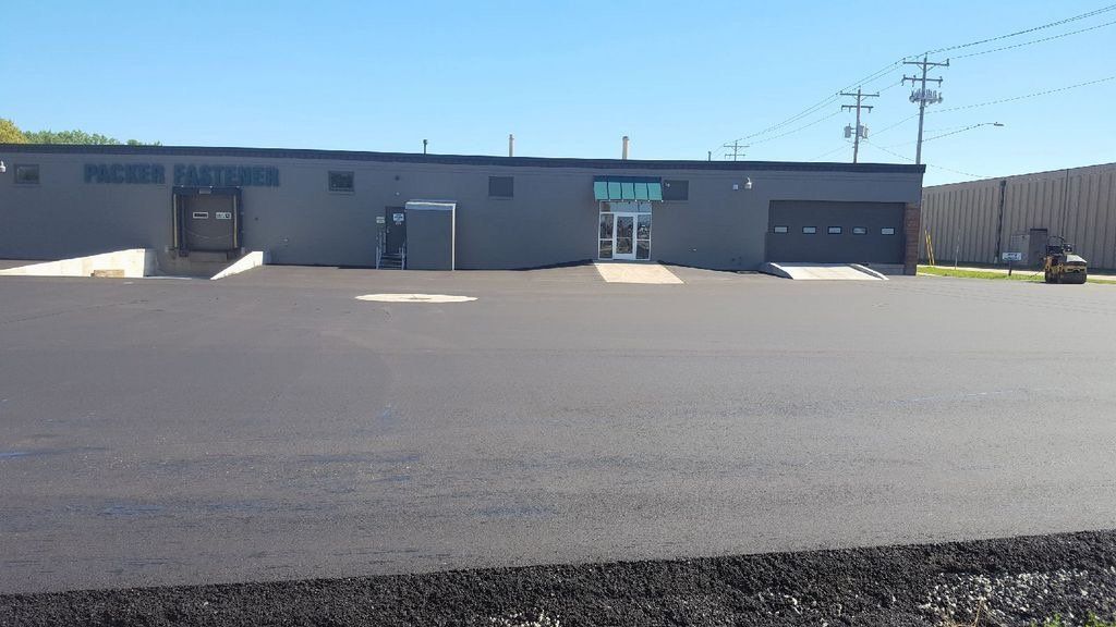 A large building with a parking lot in front of it