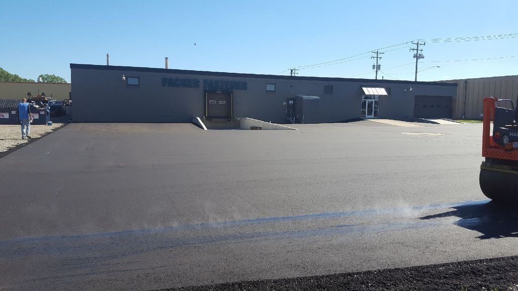 A forklift is sitting in front of a large building