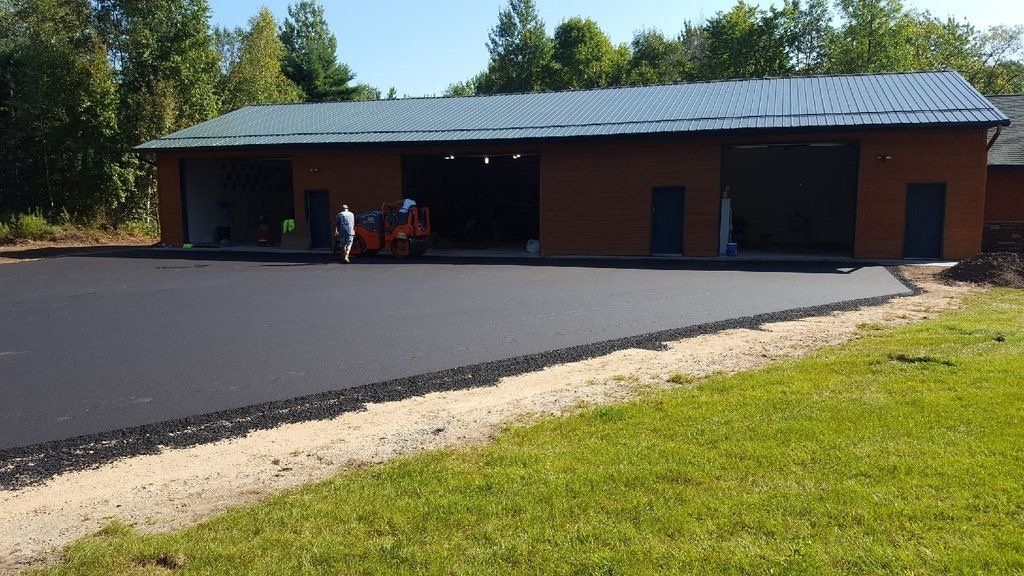 A large brick building with a green roof is being built.