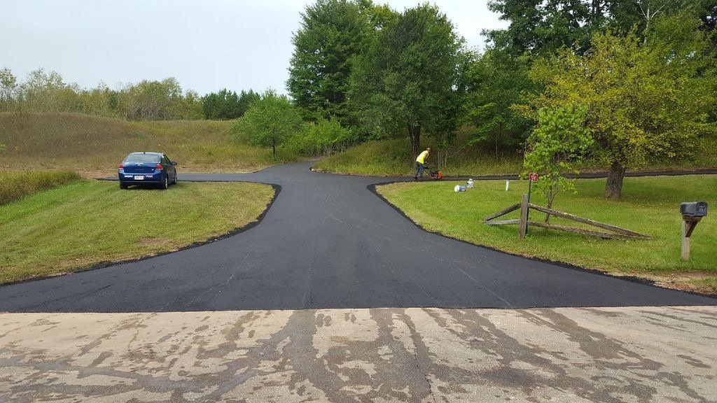 A blue car is parked on the side of a road