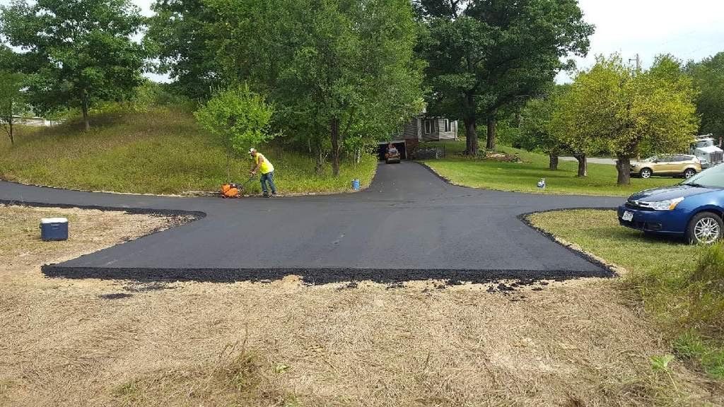 A blue car is parked on the side of a road.