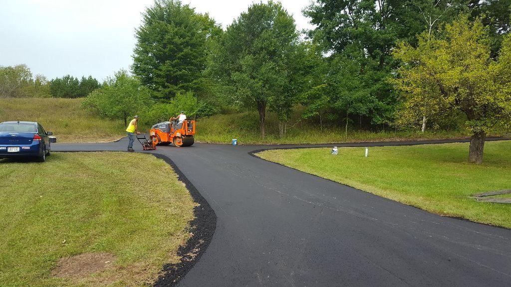 A blue car is parked on the side of a road.