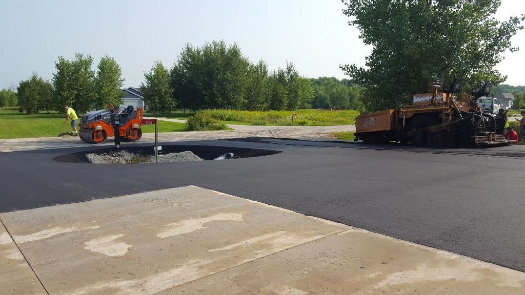 A road is being paved in a parking lot