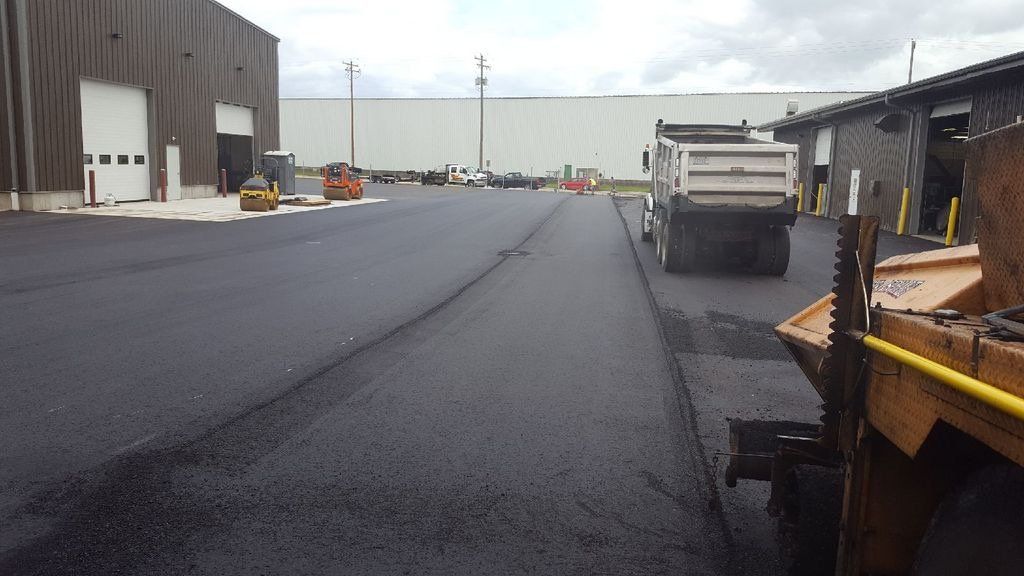 A dump truck is parked on the side of the road