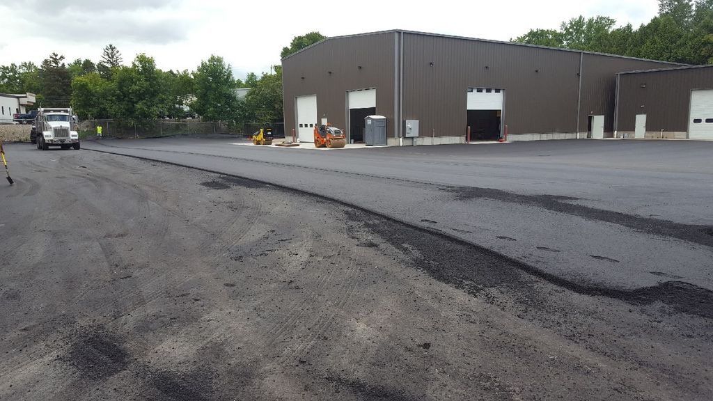 A truck is parked in front of a large building