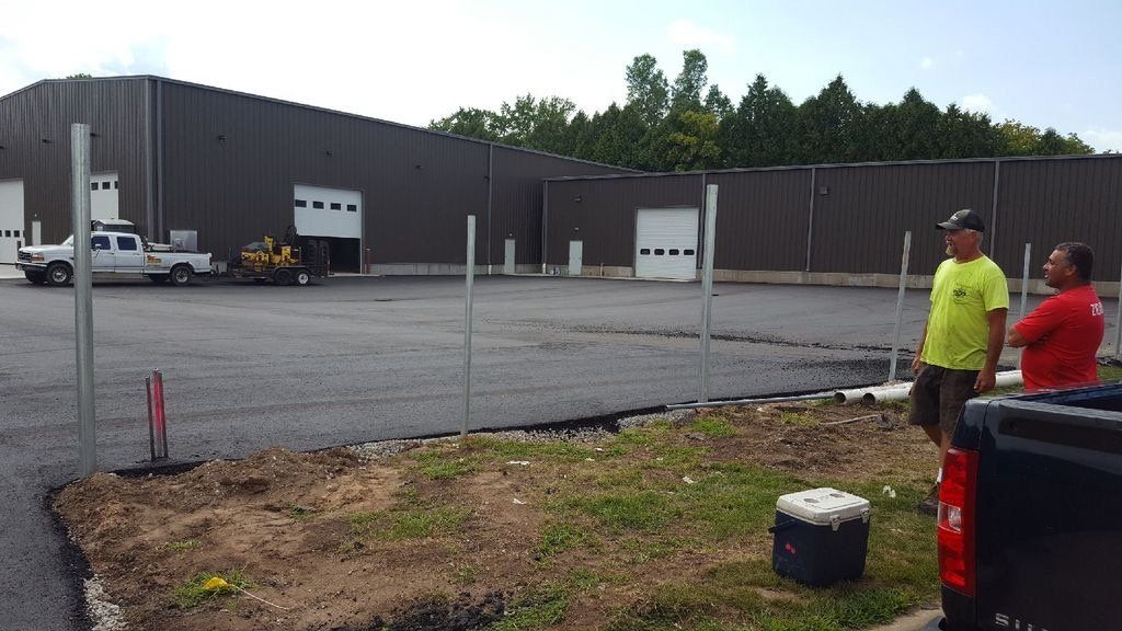 Two men are standing in front of a large building