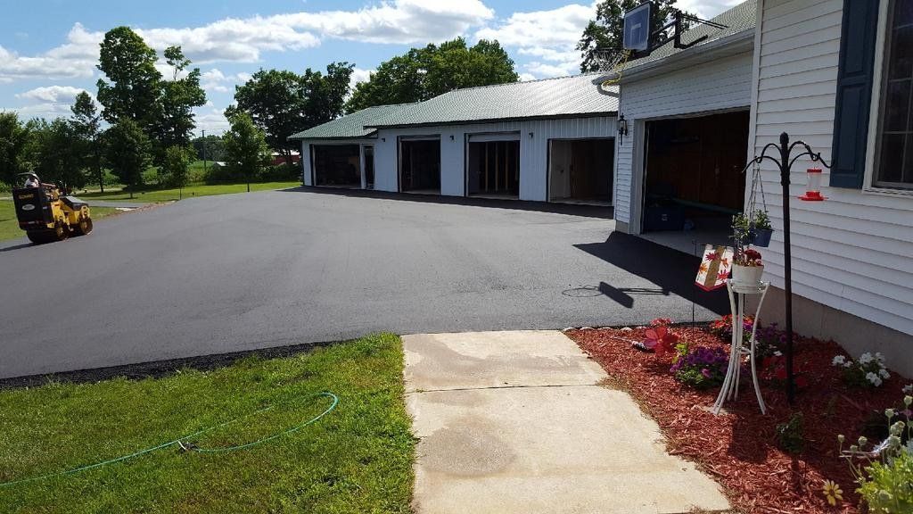 A house with a driveway and a walkway leading to it