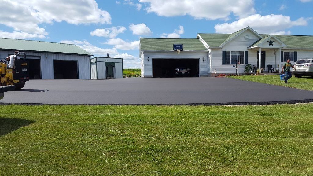 A large house with a large driveway in front of it.