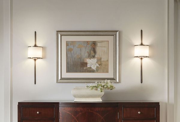 There is a picture on the wall above the dresser.