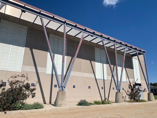 A large building with a blue sky in the background