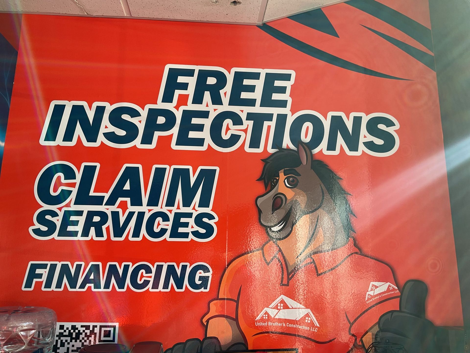 Red banner ad for free inspections, claims, services, and financing with a dog mascot in an orange shirt