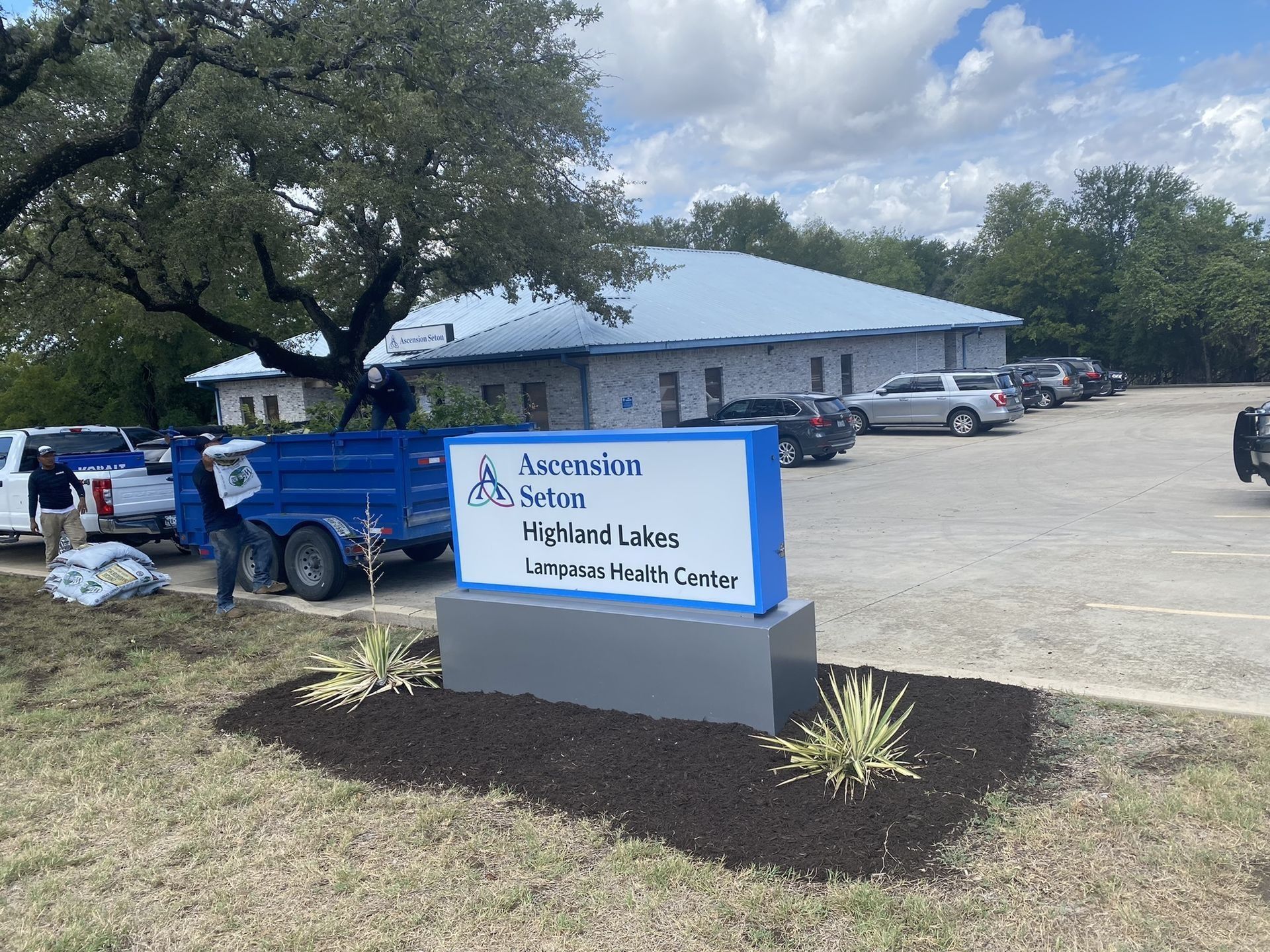 Sign for Ascension Seton Highland Lakes Urgent Health Center, cars, and building.