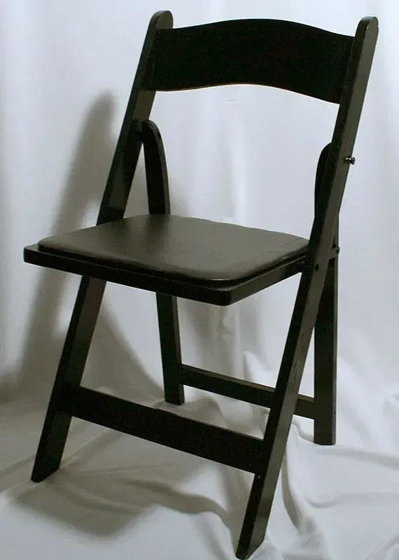 A dark wooden folding chair with a padded seat, shown against a plain white background.