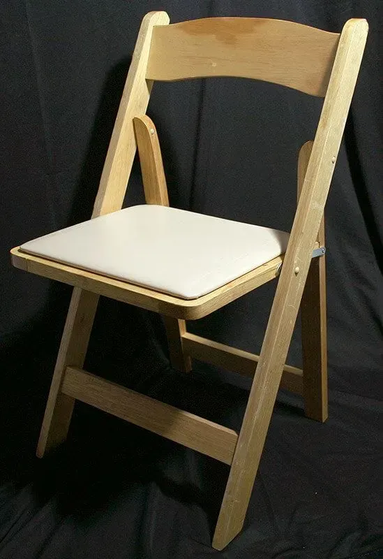 A wooden folding chair with a white padded seat, shown against a plain black background.