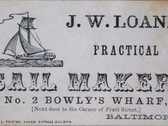 A black and white advertisement for J.W. Loane, Sail Maker, located at No. 2 Bowly’s Wharf, Baltimore, with an illustration.