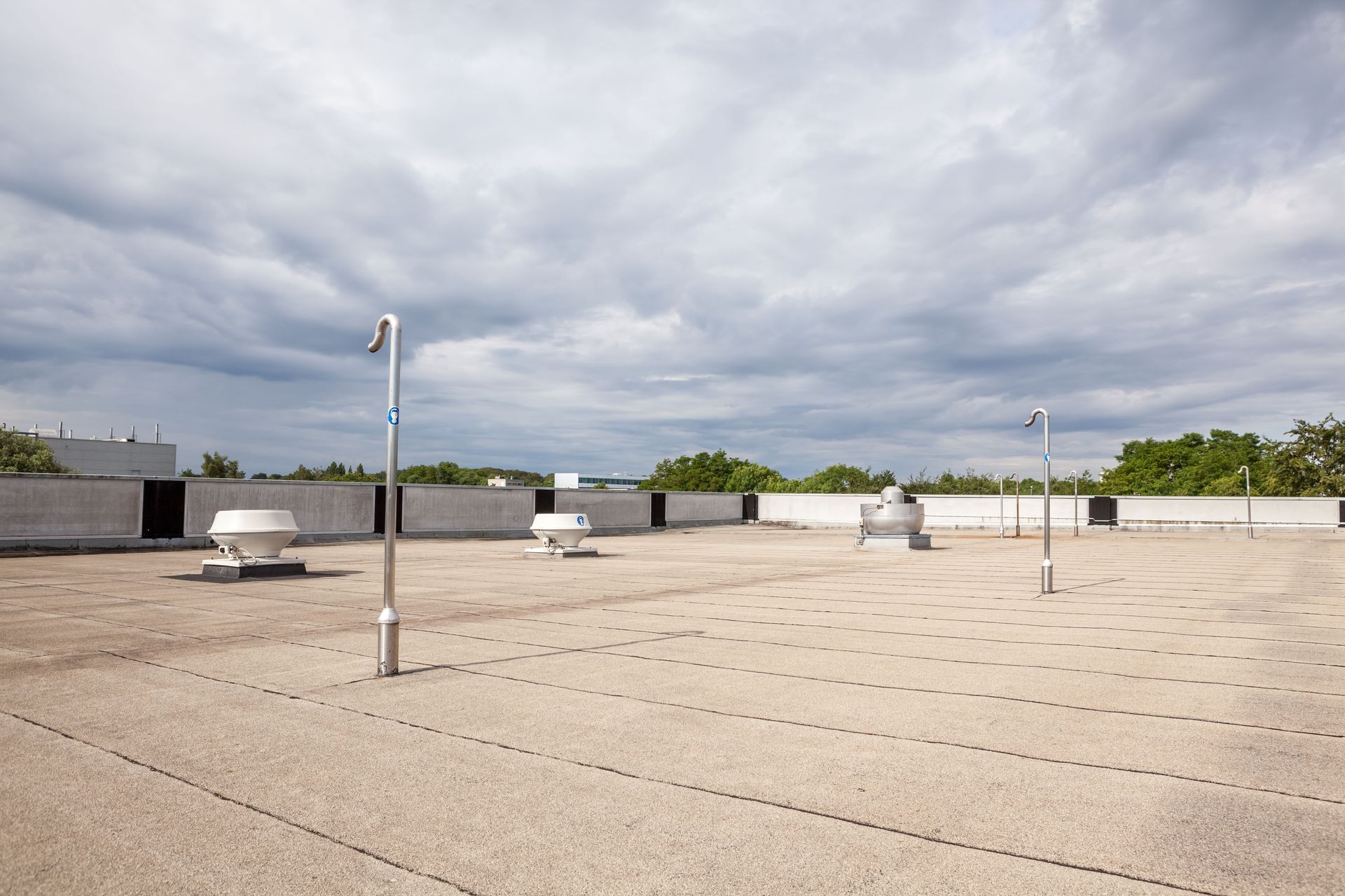 An empty rooftop with a cloudy sky in the background