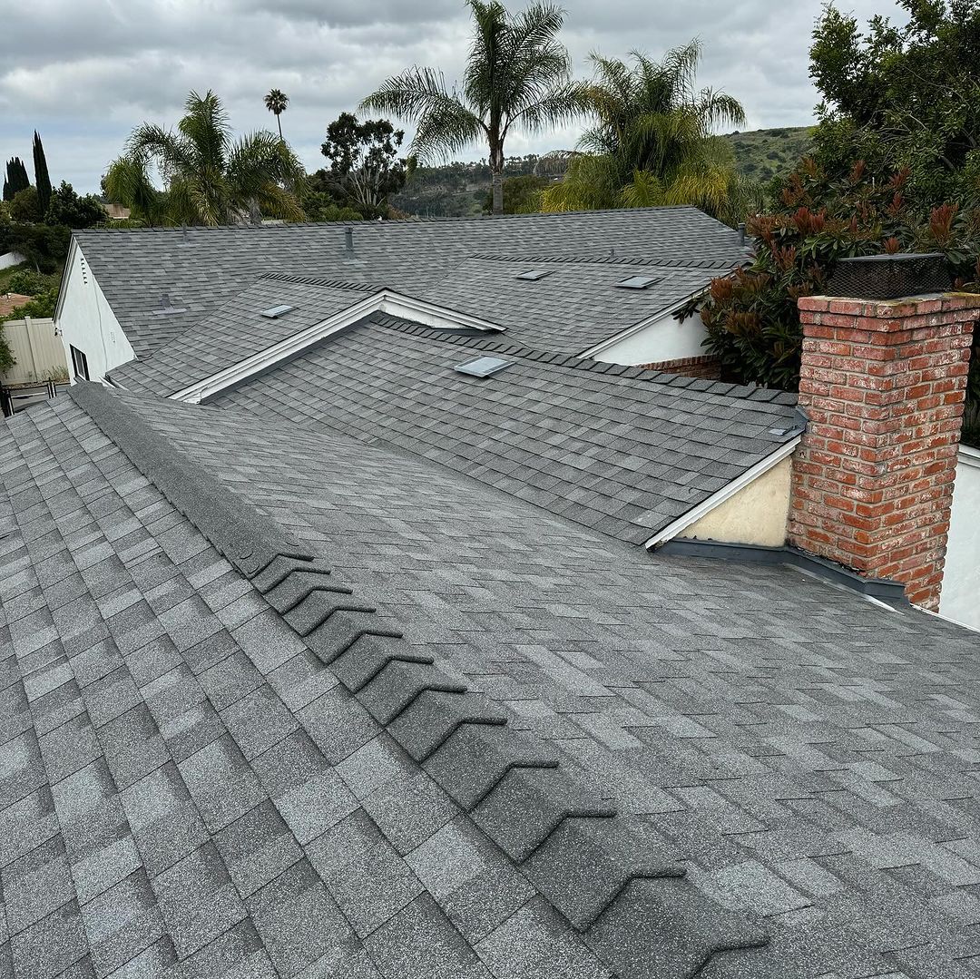 A roof of a house with a chimney and stairs on it.