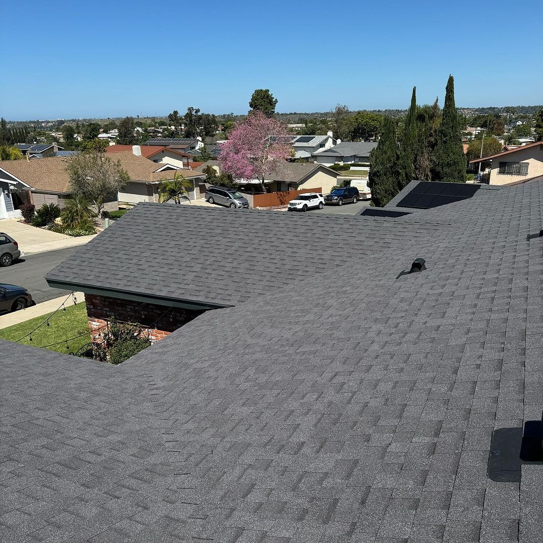An aerial view of a roof of a house in a residential area.