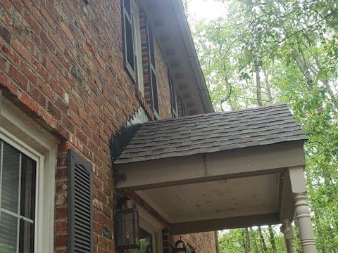 Brick house with a small covered porch.