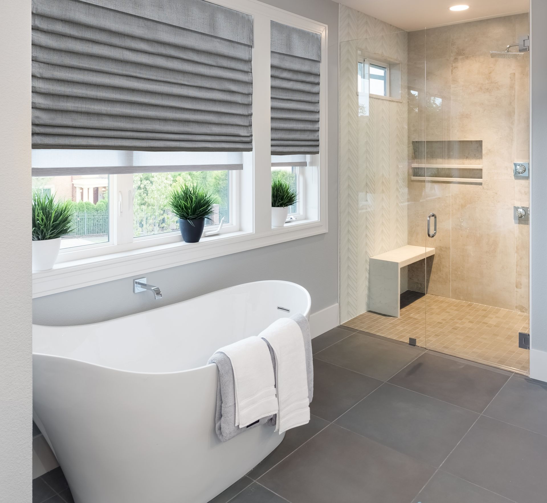 A bathroom with a bathtub and a walk in shower.