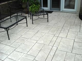 A patio with a table and chairs on it.