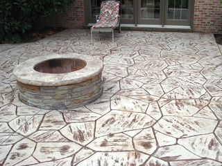 There is a fire pit in the middle of the patio.