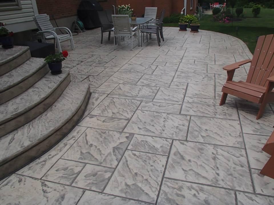 A patio with a table and chairs and stairs