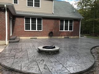 There is a fire pit in the middle of the patio.