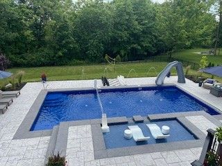 An aerial view of a large swimming pool with a slide.