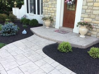 There is a walkway leading to the front door of a house.
