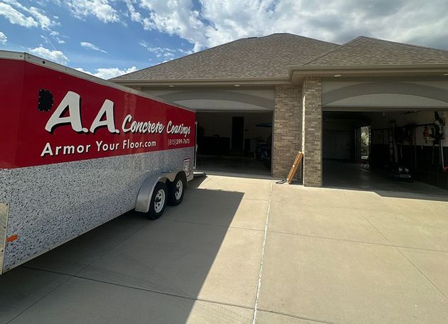 AA Custom Cleaning service truck parked in front of a suburban house with an open garage.