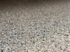 Close-up of a speckled beige and gray carpet or floor texture