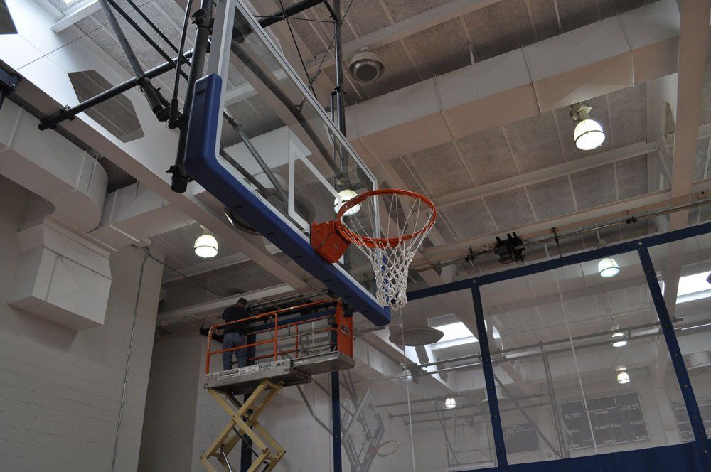 Motorized basketball hoops and side basket installation