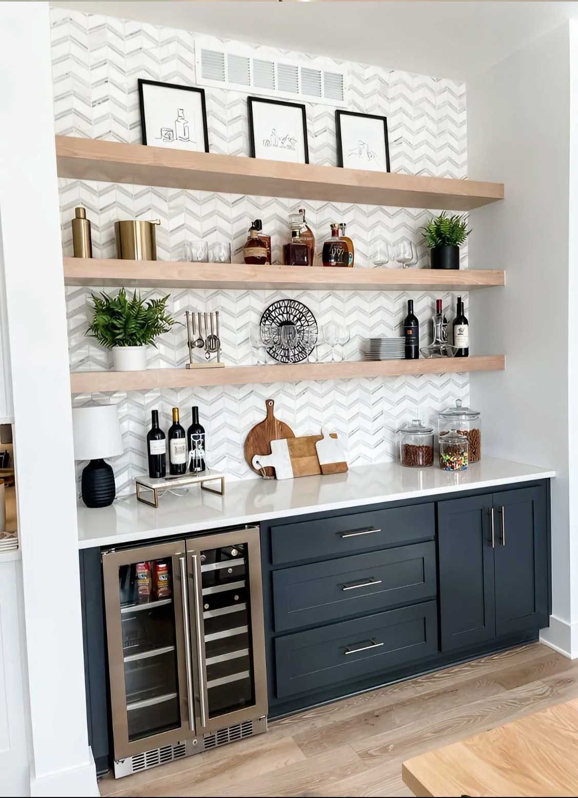 Built-in home bar with shelves and cabinetry in a kitchen setting. Includes wine cooler, liquor bottles, and decor.