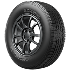 A close up of a tire on a wheel on a white background.